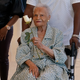 Viola Fletcher, center, the oldest living survivor of the Tulsa race massacre, holds a rose she received as she arrives for a luncheon honoring survivors Saturday, May 29, 2021, in Tulsa, Okla.